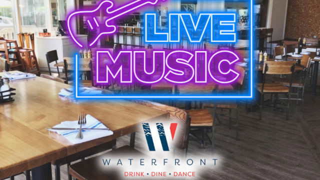 An empty restaurant with a neon sign reading 