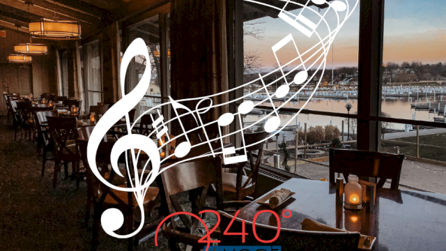A dining area with musical notes and a treble clef, overlooking a waterfront view at sunset. Text reads 
