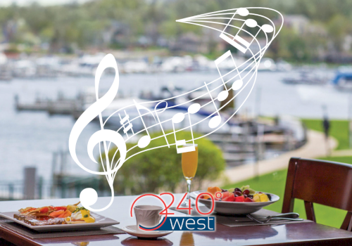 A table with plates of food overlooks a waterfront. Musical notes are superimposed. The logo 