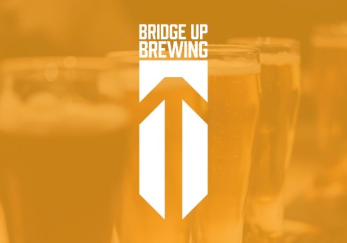 A blurred orange background with beer glasses and a white Bridge Up Brewing logo in the center, top text reads “BRIDGE UP BREWING” ending with a period.