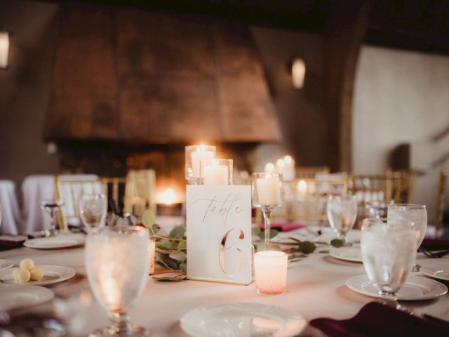 A beautifully set dinner table with candles, a 