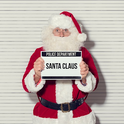 Santa Claus holding a police department sign in front of a lineup background. Ends the sentence.