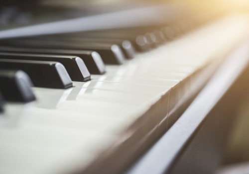 A close-up of piano keys with soft lighting highlighting the keys from the upper right corner, creating a warm and inviting atmosphere.